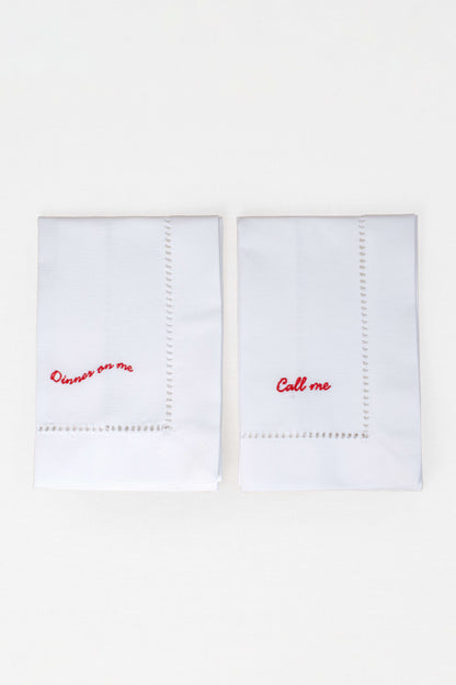 Two white handkerchiefs with red text on a white background
